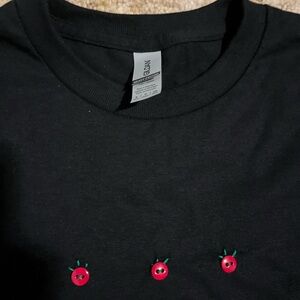 handmade embroidered with buttons, small black T-shirt, cherry tomatoes